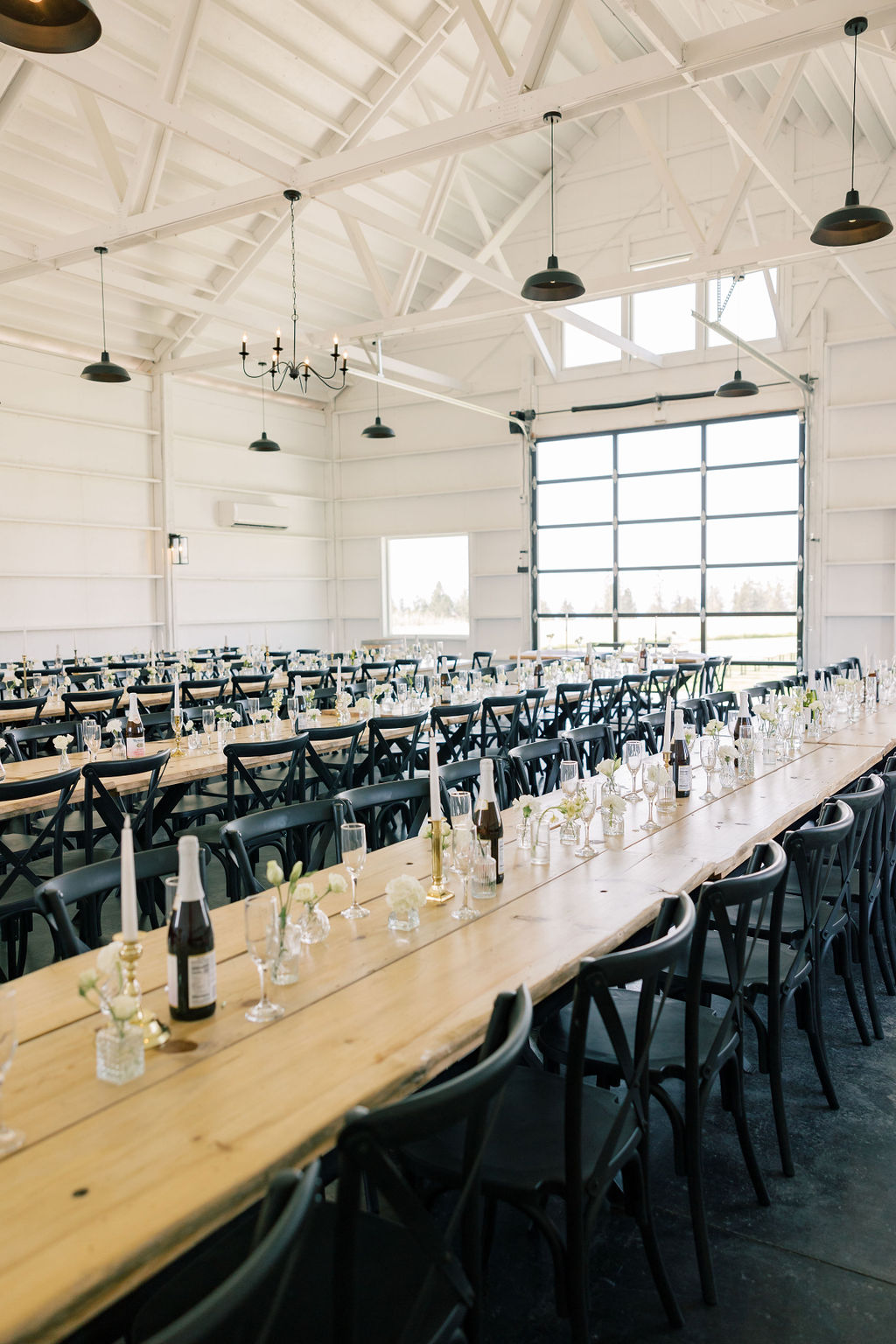 View of the inside of a wedding reception venue inside a barn