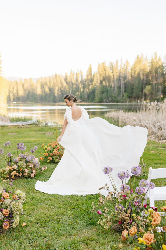 A bride dances in the aisle of her ceremony location at one of the lakefront wedding venues coeur d'alene