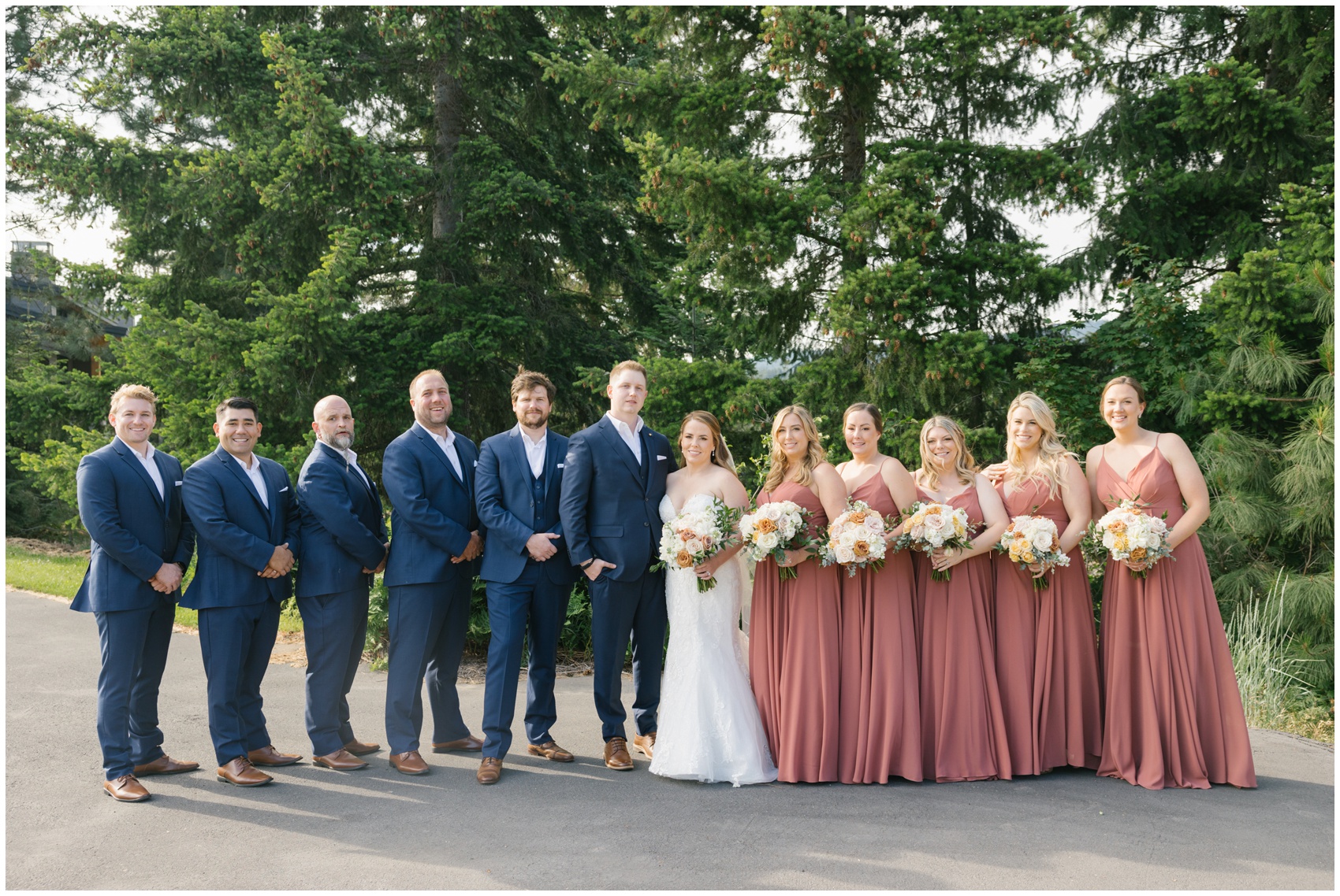 Newlyweds Stand with their bridal parties on either side of them