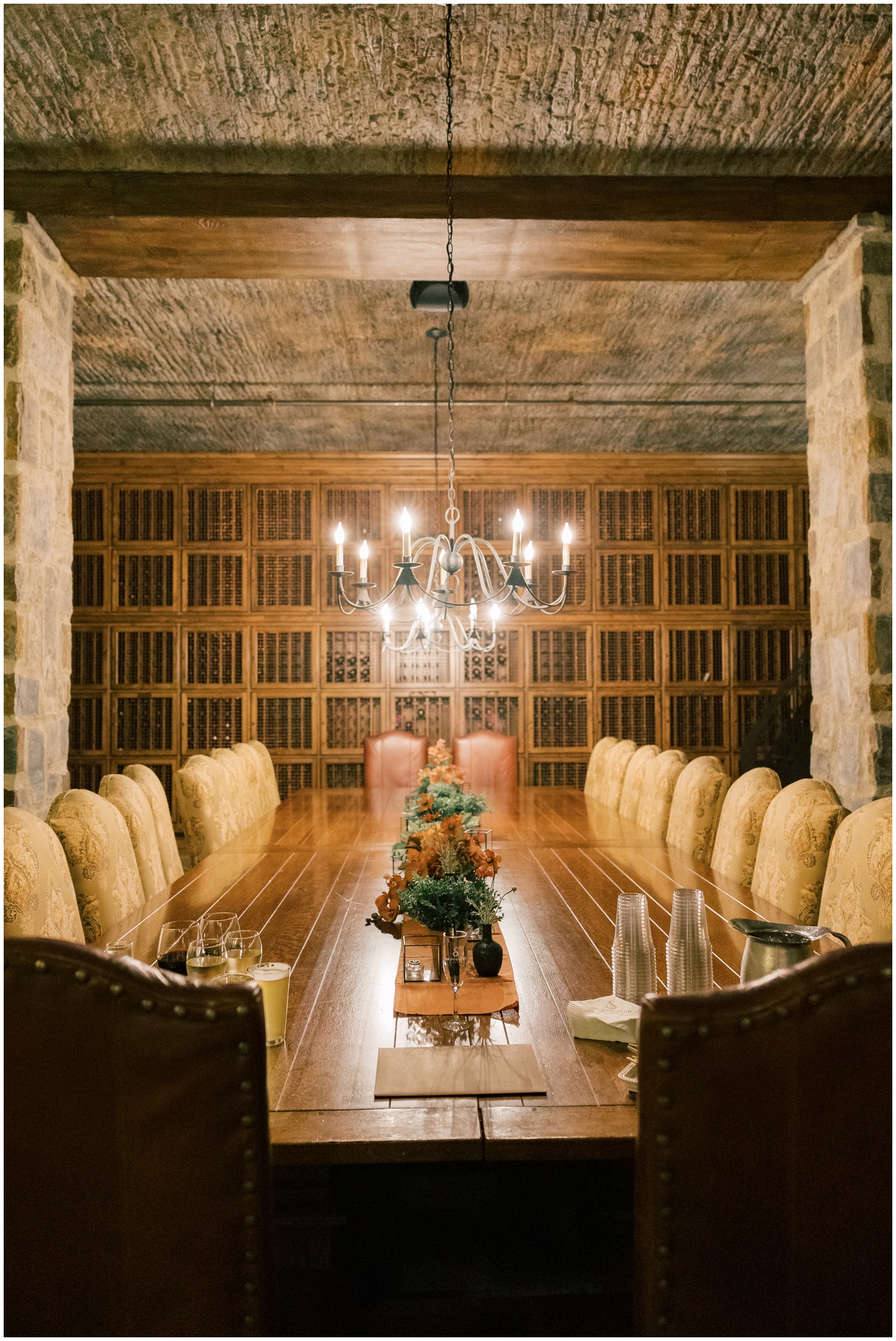 Details of a long wooden table in a cellar at the swiftwater cellars wedding venue