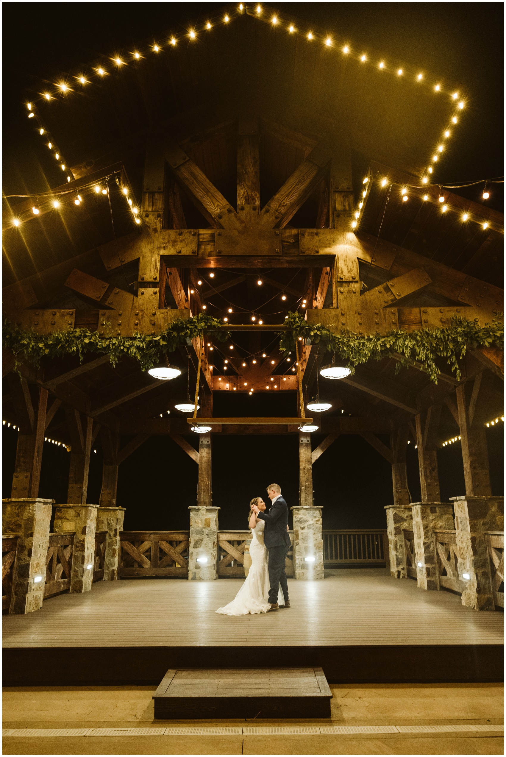 Newlyweds dance alone under a large overhang at their swiftwater cellars wedding