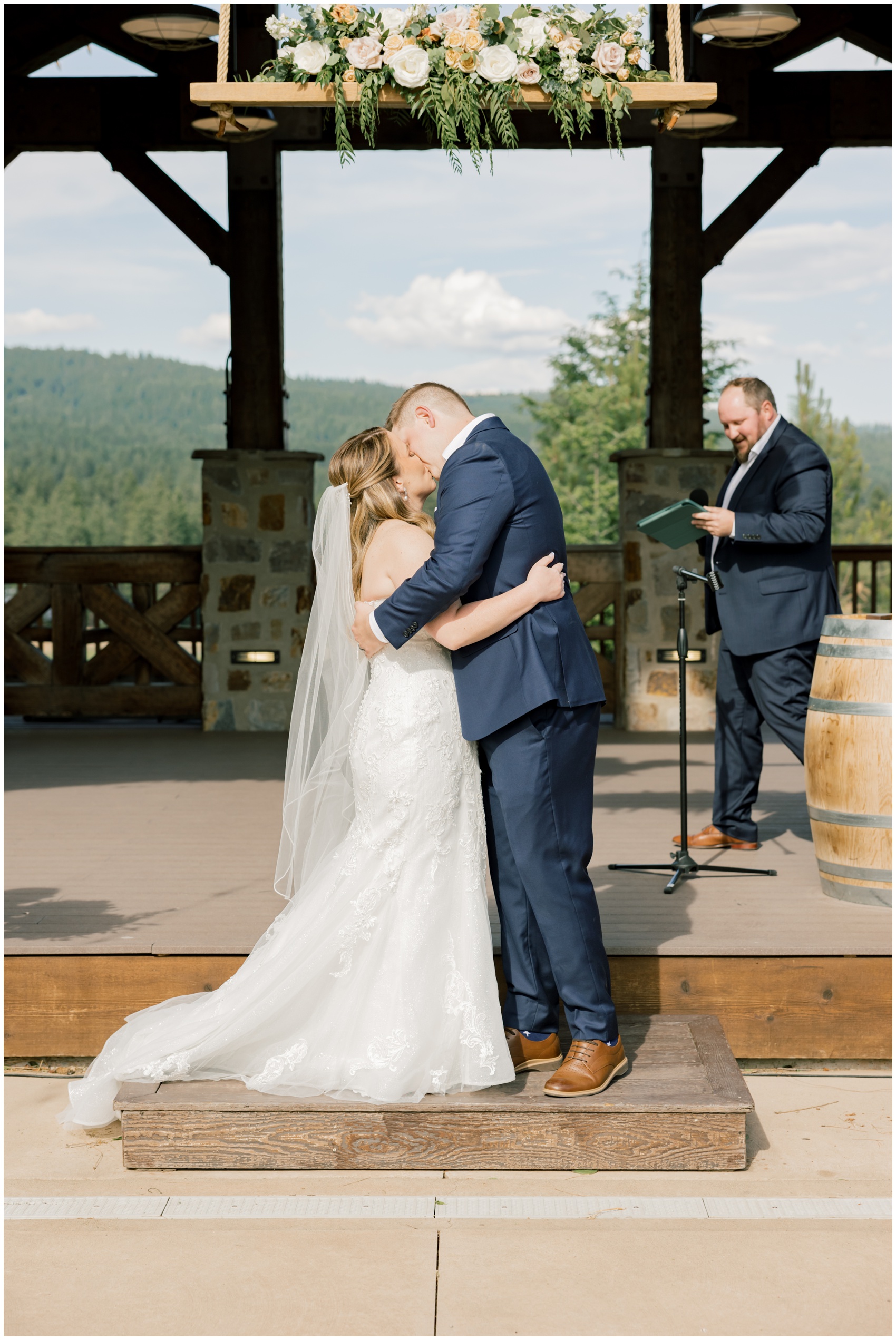 Newlyweds kiss at the altar to end their outdoor ceremony