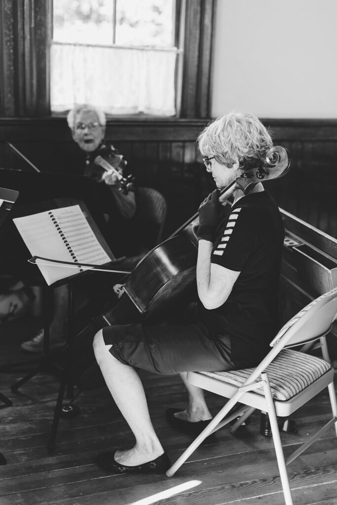 A string trio plays in the chapel for a wedding