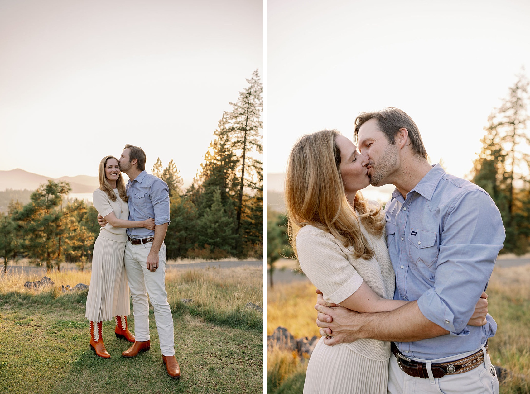 A happy couple in cream dress and blue button down kiss and hug on a mountain at sunset